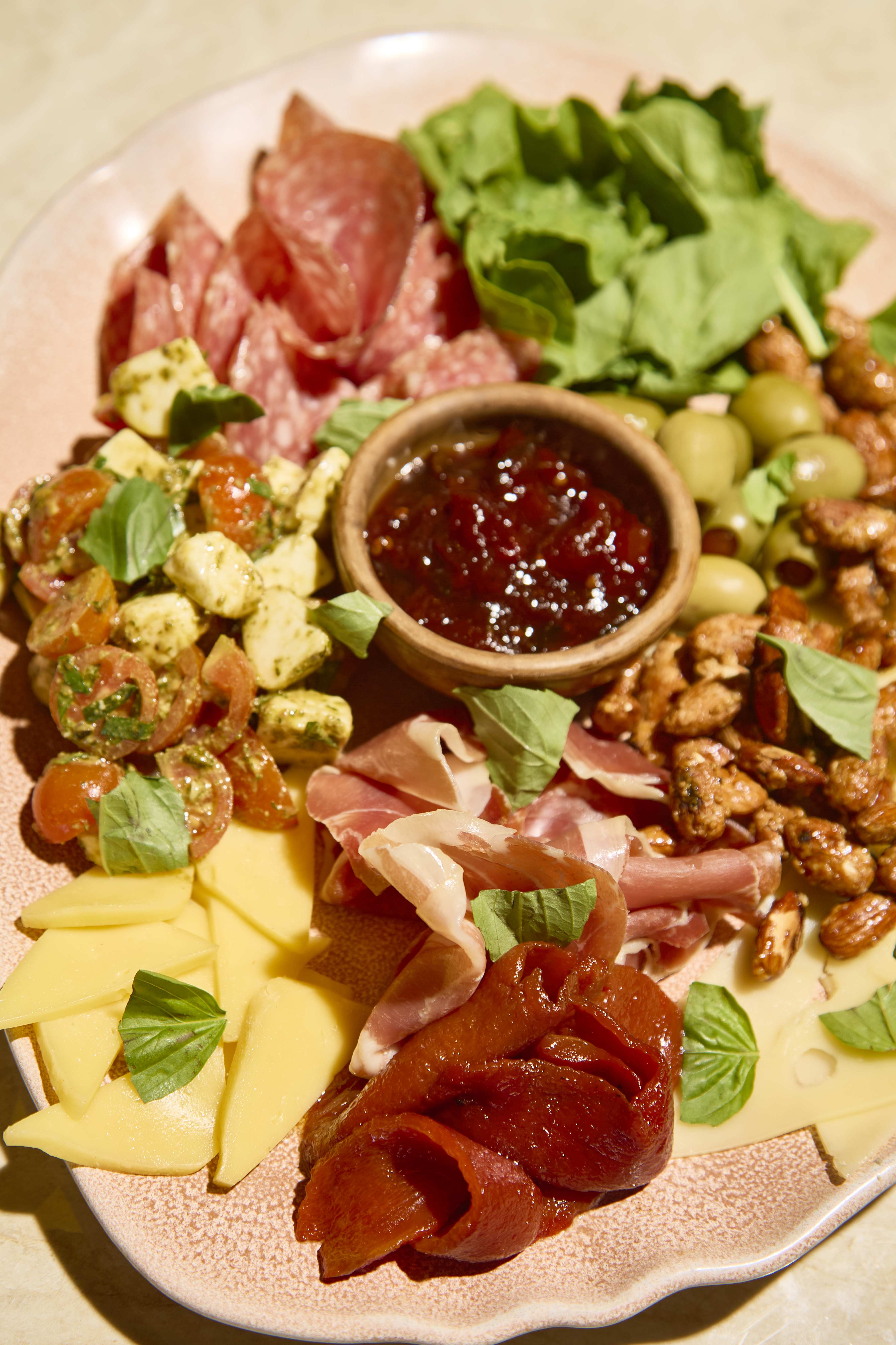 Antipasto board with cured meats, cheese, and olives